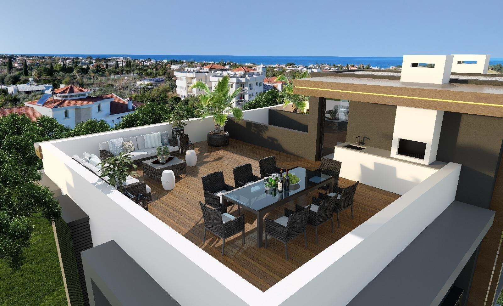 Rooftop terrace with outdoor kitchen, lounge and dining for eight, looking out to the sea